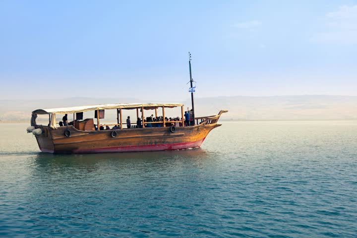A wooden boat on the Sea of Galilee in the morning light